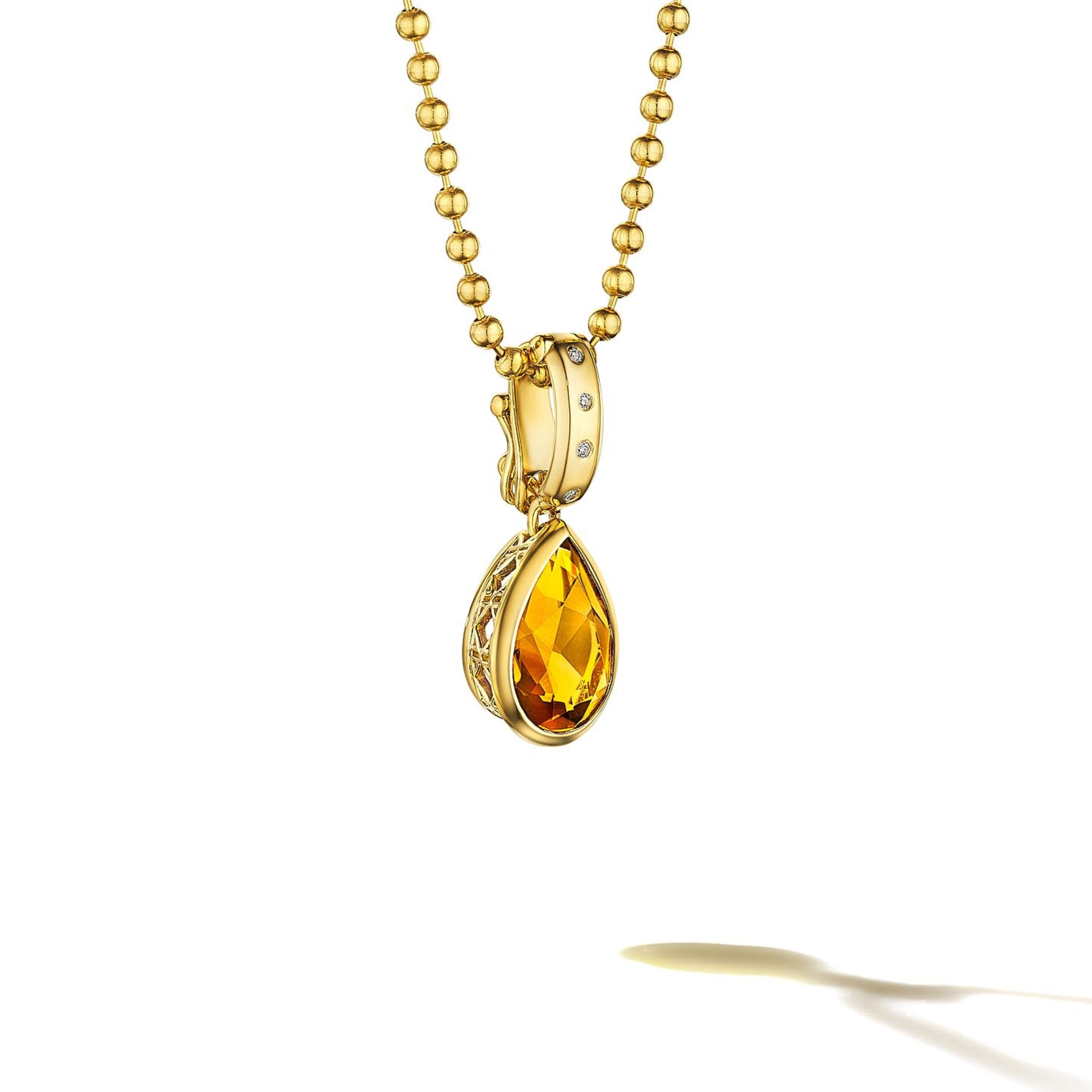 MoAnA LUU Dlo pear-shaped citrine pendant in 18K yellow gold, featuring a cane-woven frame inspired by traditional Caribbean fish traps, reflecting the house’s vision of Creole-inspired fine jewelry crafted in New York.