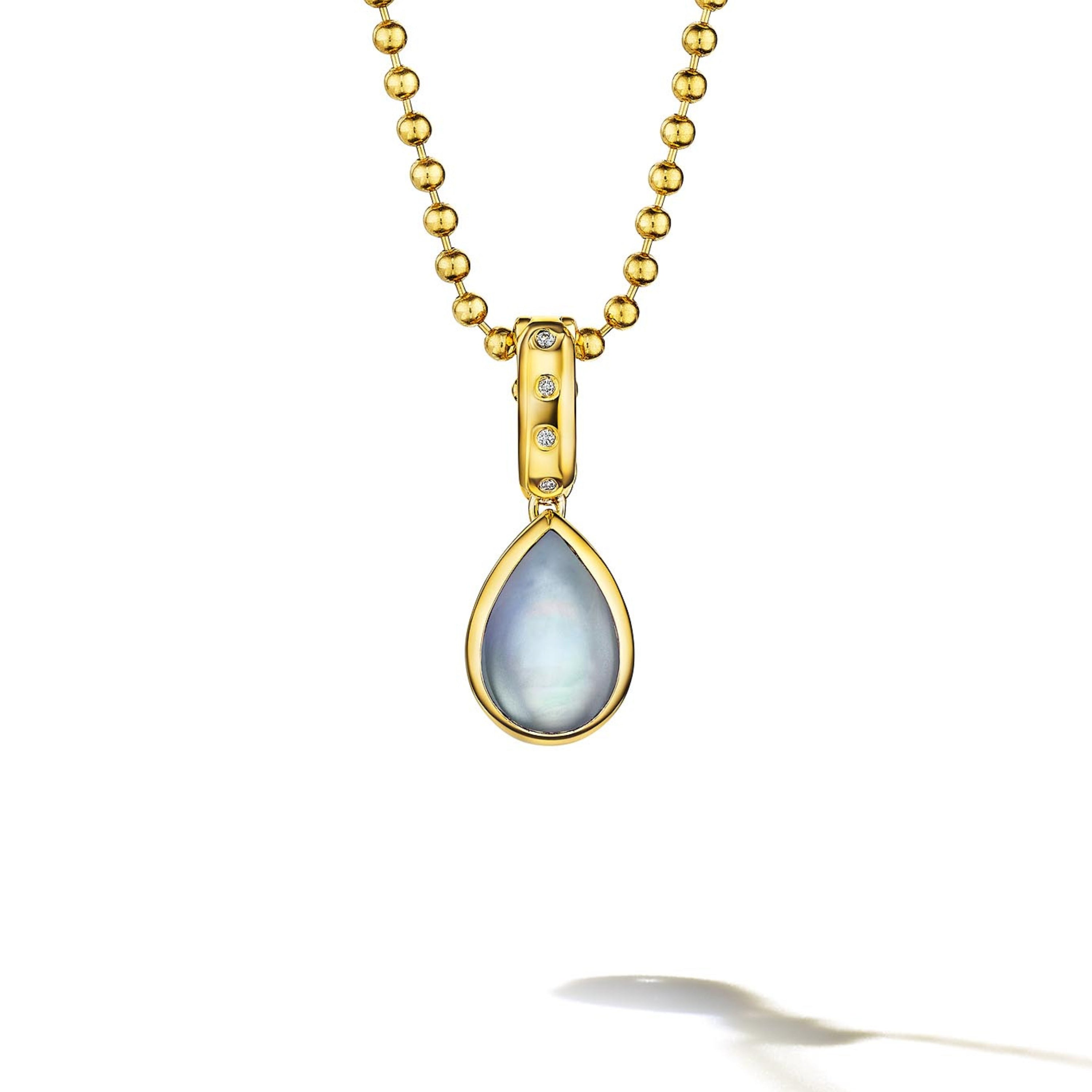 MoAnA LUU Dlo pear-shaped moonstone pendant in 18K yellow gold, featuring a cane-woven frame inspired by traditional Caribbean fish traps, reflecting the house’s vision of Creole-inspired fine jewelry crafted in New York.