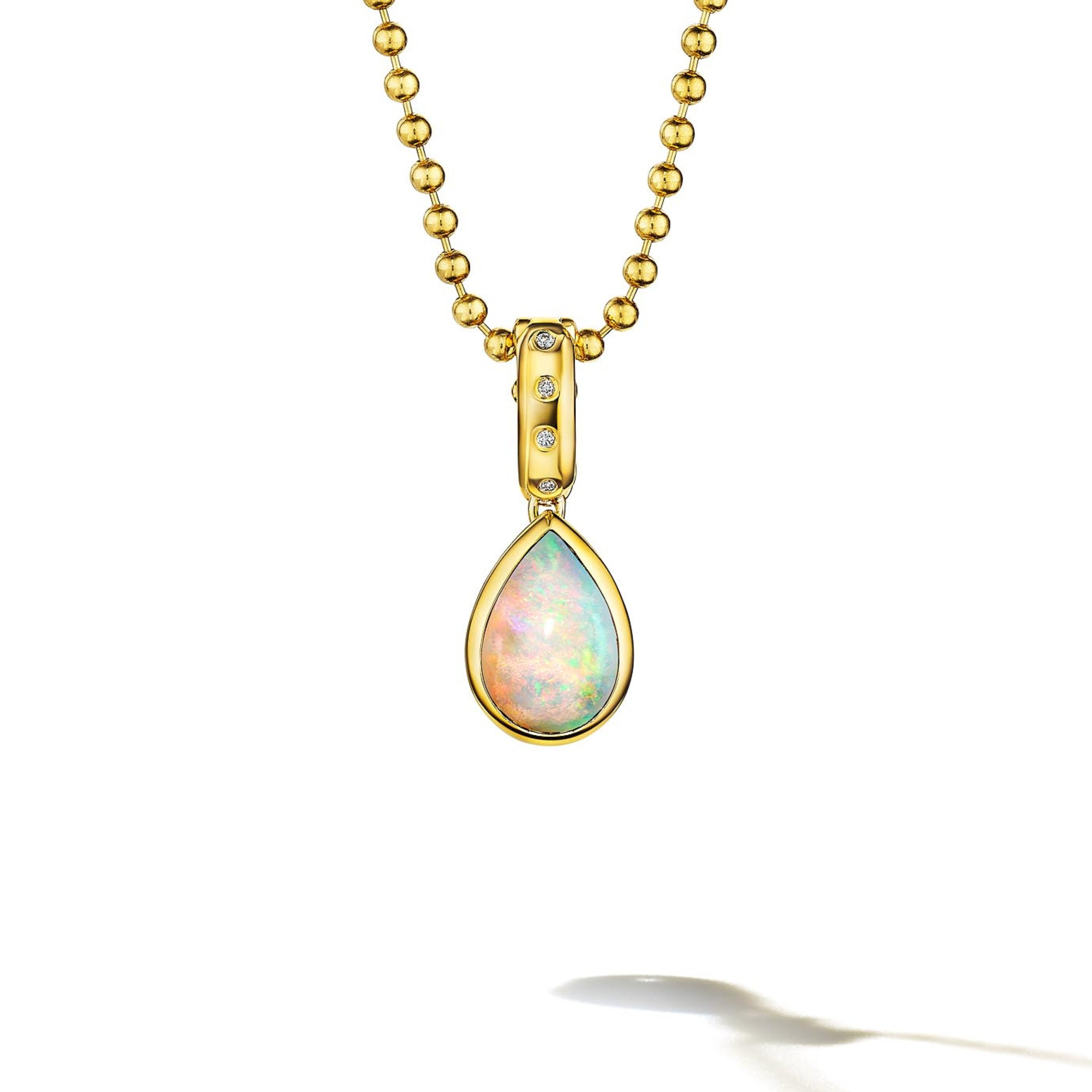 MoAnA LUU Dlo pear-shaped opal pendant in 18K yellow gold, featuring a cane-woven frame inspired by traditional Caribbean fish traps, reflecting the house’s vision of Creole-inspired fine jewelry crafted in New York.