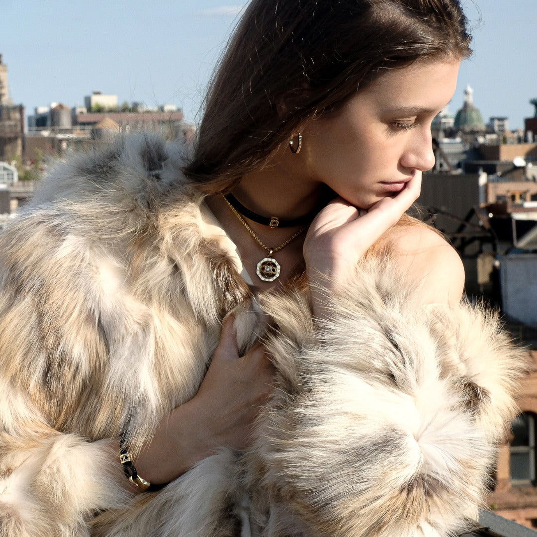 MoAnA LUU fine jewelry worn on model, featuring Abyss stingray leather choker and bracelet with gold and elements, paired with Doudou octagonal pendant necklace in 18K yellow gold inspired by Caribbean fish traps.