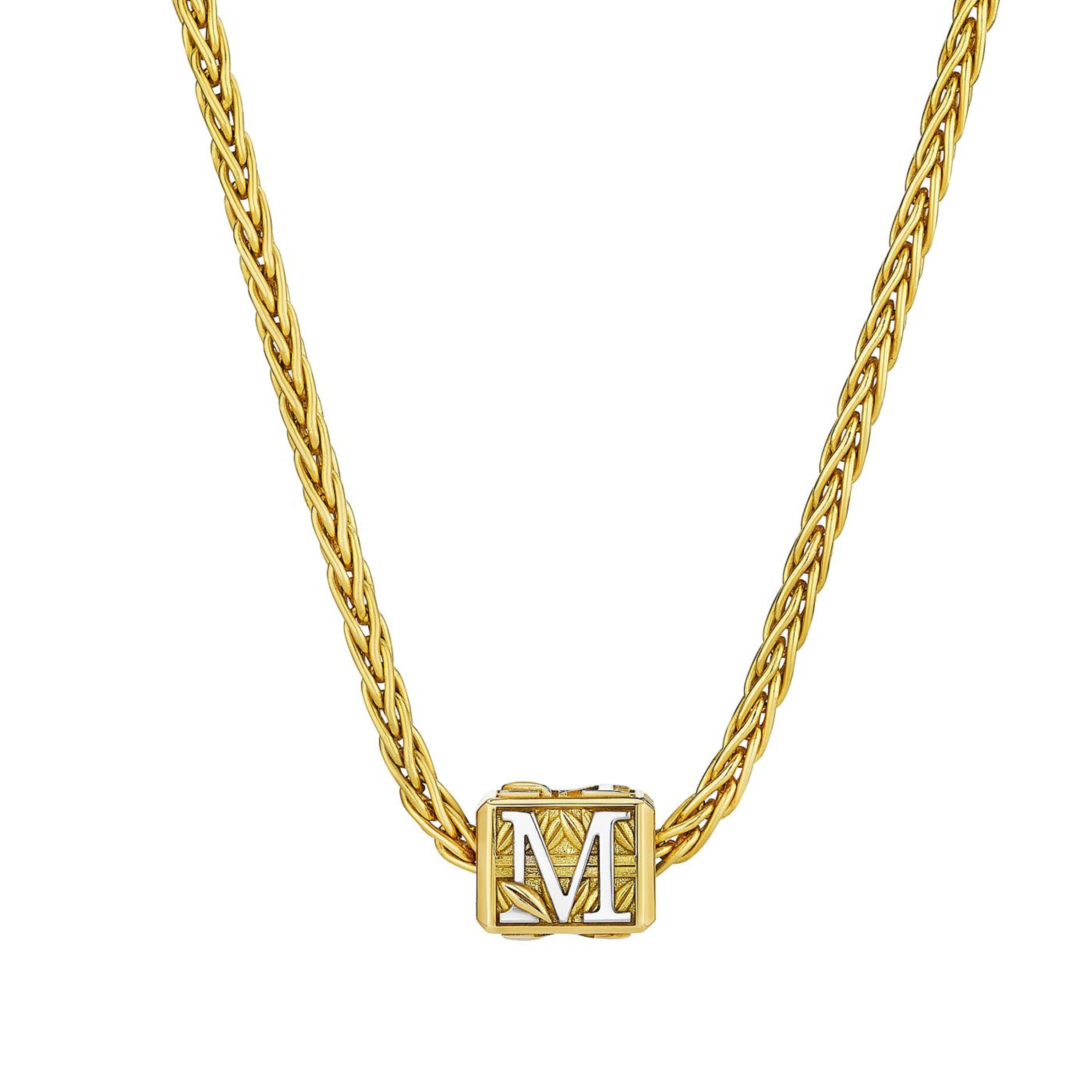 MoAnA LUU Foyal bead necklace in 18K yellow gold, featuring a wheat chain and “M” letter charm inspired by Creole architectural design.