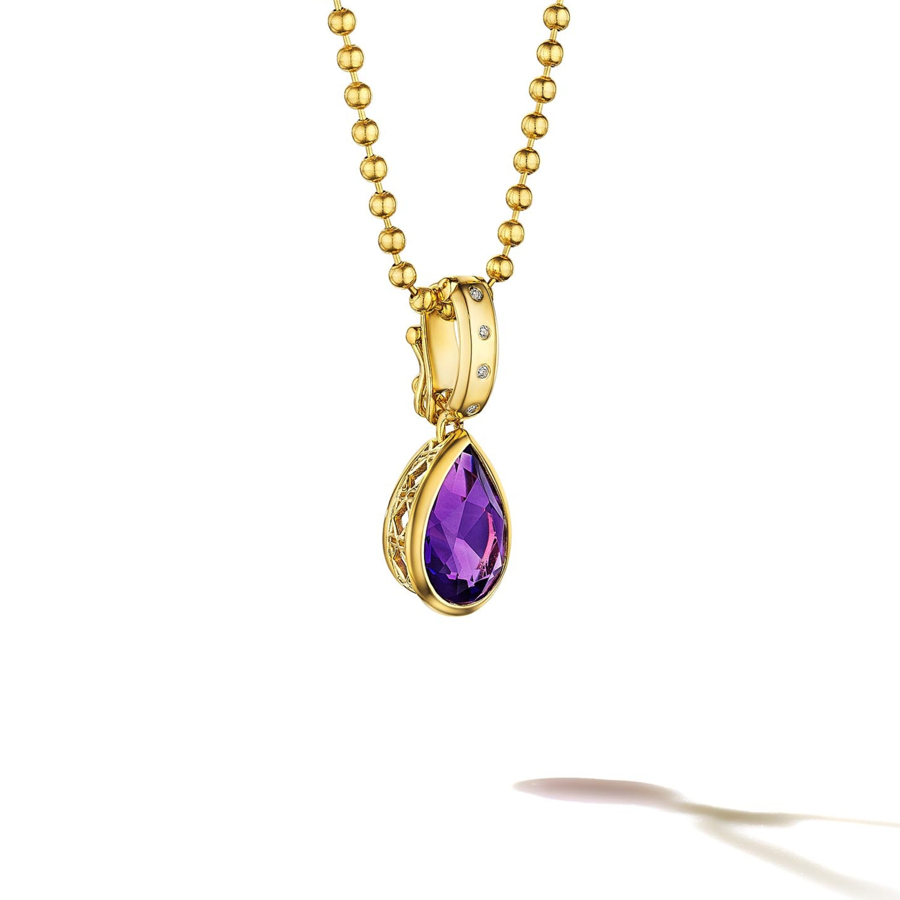 MoAnA LUU Dlo pear-shaped amethyst pendant in 18K yellow gold, featuring a cane-woven frame inspired by traditional Caribbean fish traps, reflecting the house’s vision of Creole-inspired fine jewelry crafted in New York.