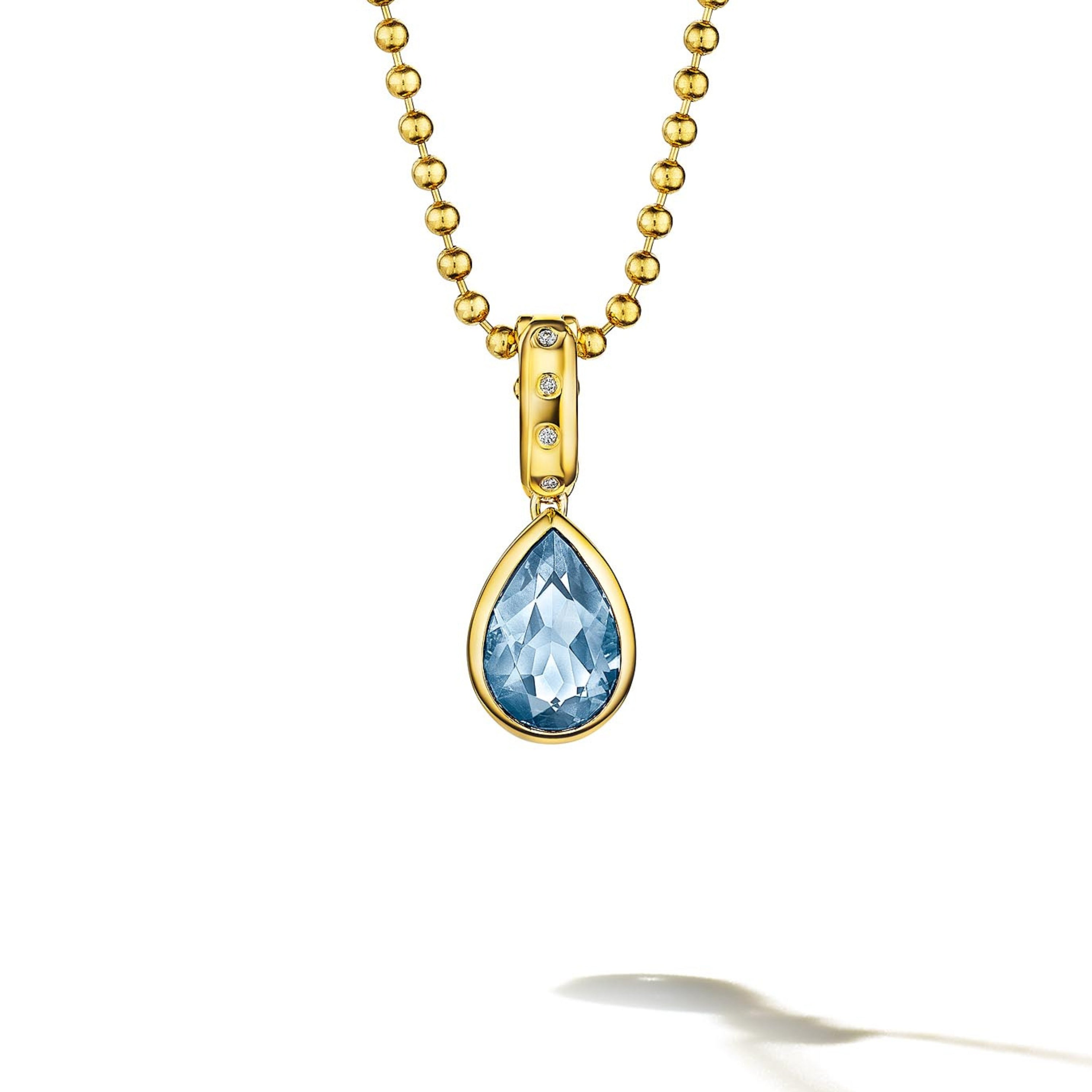 MoAnA LUU Dlo pear-shaped aquamarine pendant in 18K yellow gold, featuring a cane-woven frame inspired by traditional Caribbean fish traps, reflecting the house’s vision of Creole-inspired fine jewelry crafted in New York.