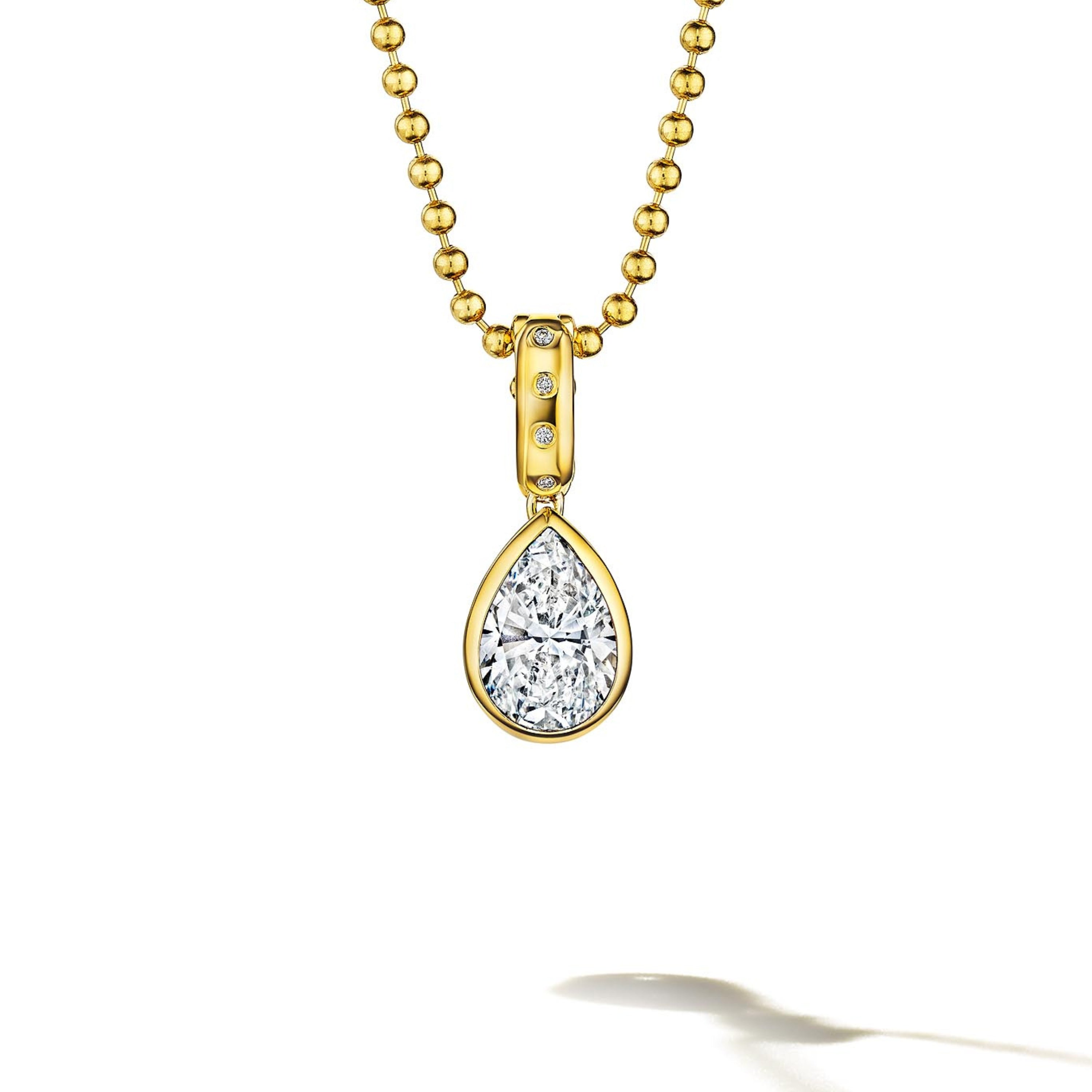 MoAnA LUU Dlo pear-shaped diamond pendant in 18K yellow gold, featuring a cane-woven frame inspired by traditional Caribbean fish traps, reflecting the house’s vision of Creole-inspired fine jewelry crafted in New York.