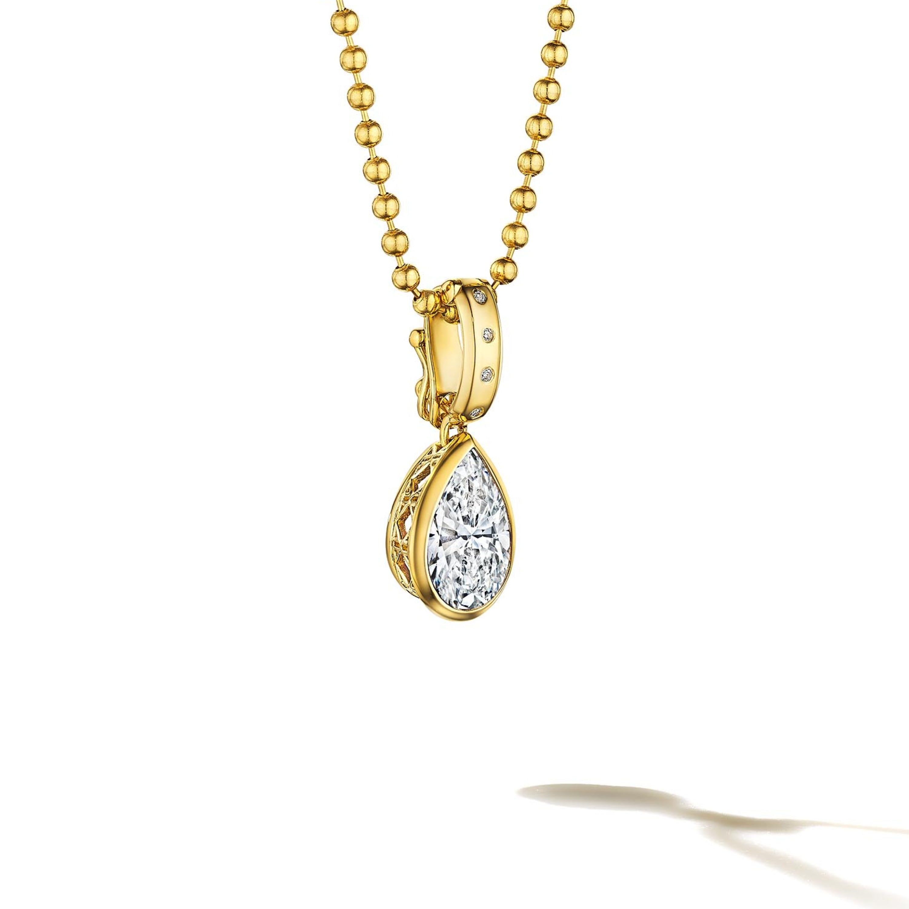 MoAnA LUU Dlo pear-shaped diamond pendant in 18K yellow gold, featuring a cane-woven frame inspired by traditional Caribbean fish traps, reflecting the house’s vision of Creole-inspired fine jewelry crafted in New York.