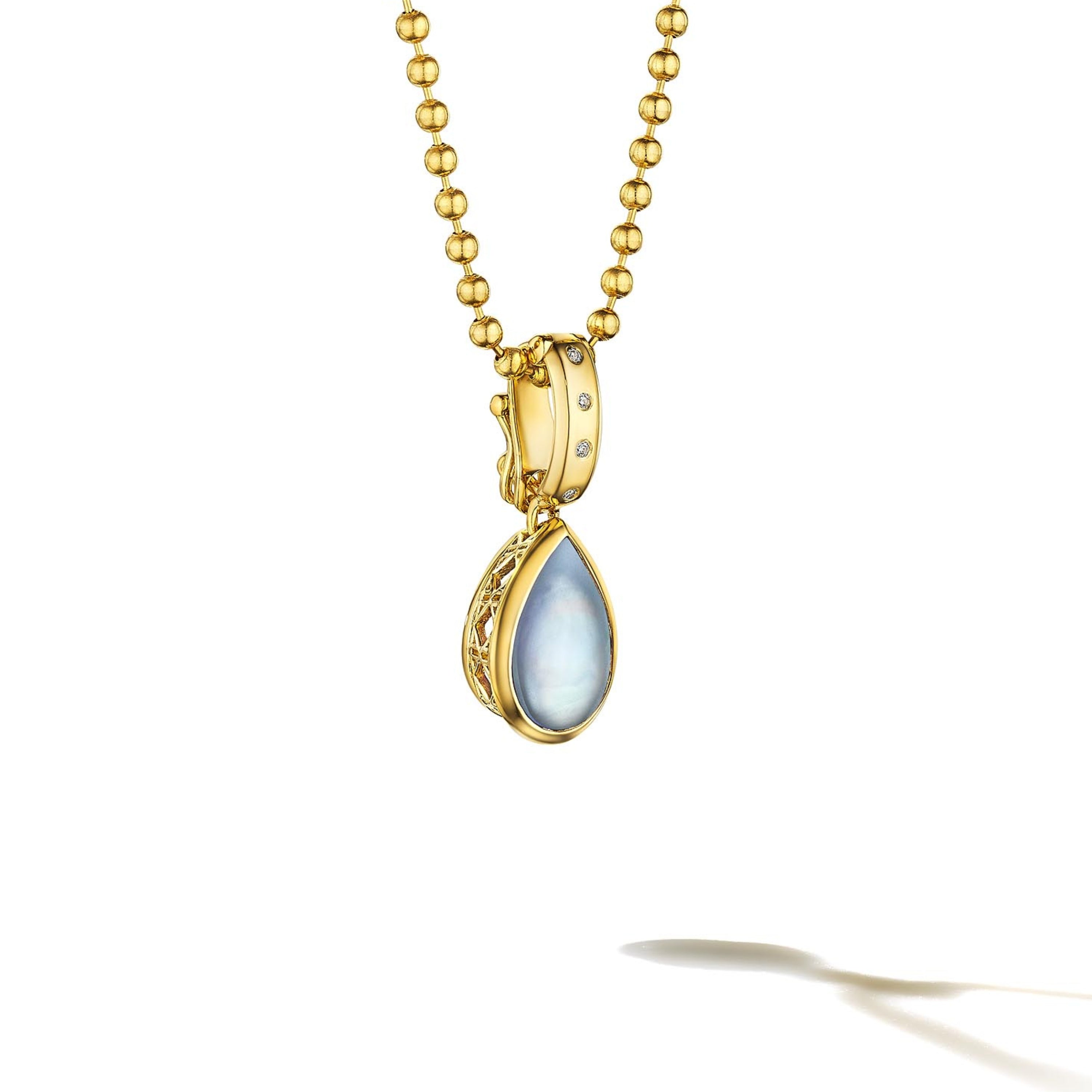 MoAnA LUU Dlo pear-shaped moonstone pendant in 18K yellow gold, featuring a cane-woven frame inspired by traditional Caribbean fish traps, reflecting the house’s vision of Creole-inspired fine jewelry crafted in New York.