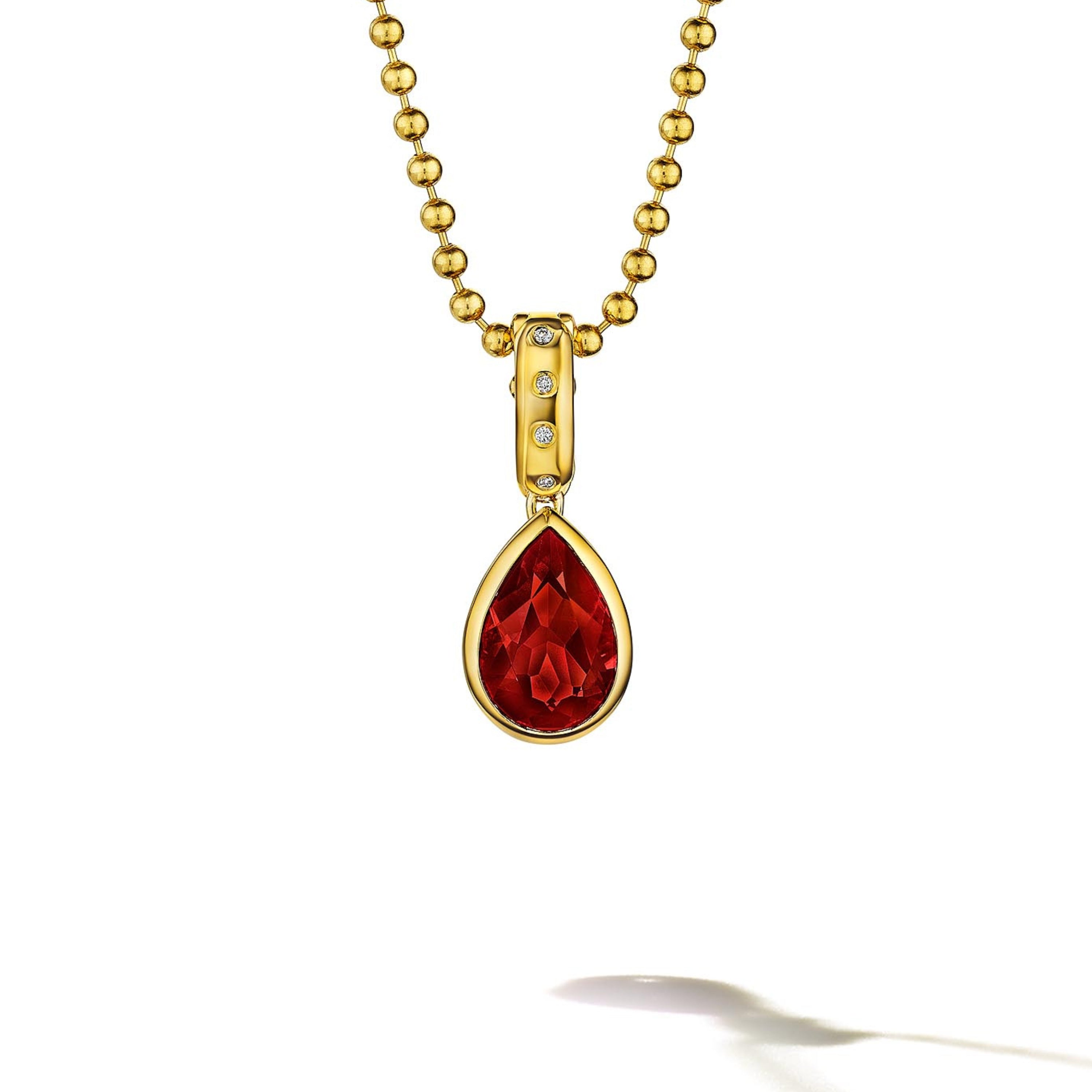 MoAnA LUU Dlo pear-shaped ruby pendant in 18K yellow gold with diamonds, featuring a cane-woven frame inspired by traditional Caribbean fish traps, reflecting the house’s vision of Creole-inspired fine jewelry crafted in New York.