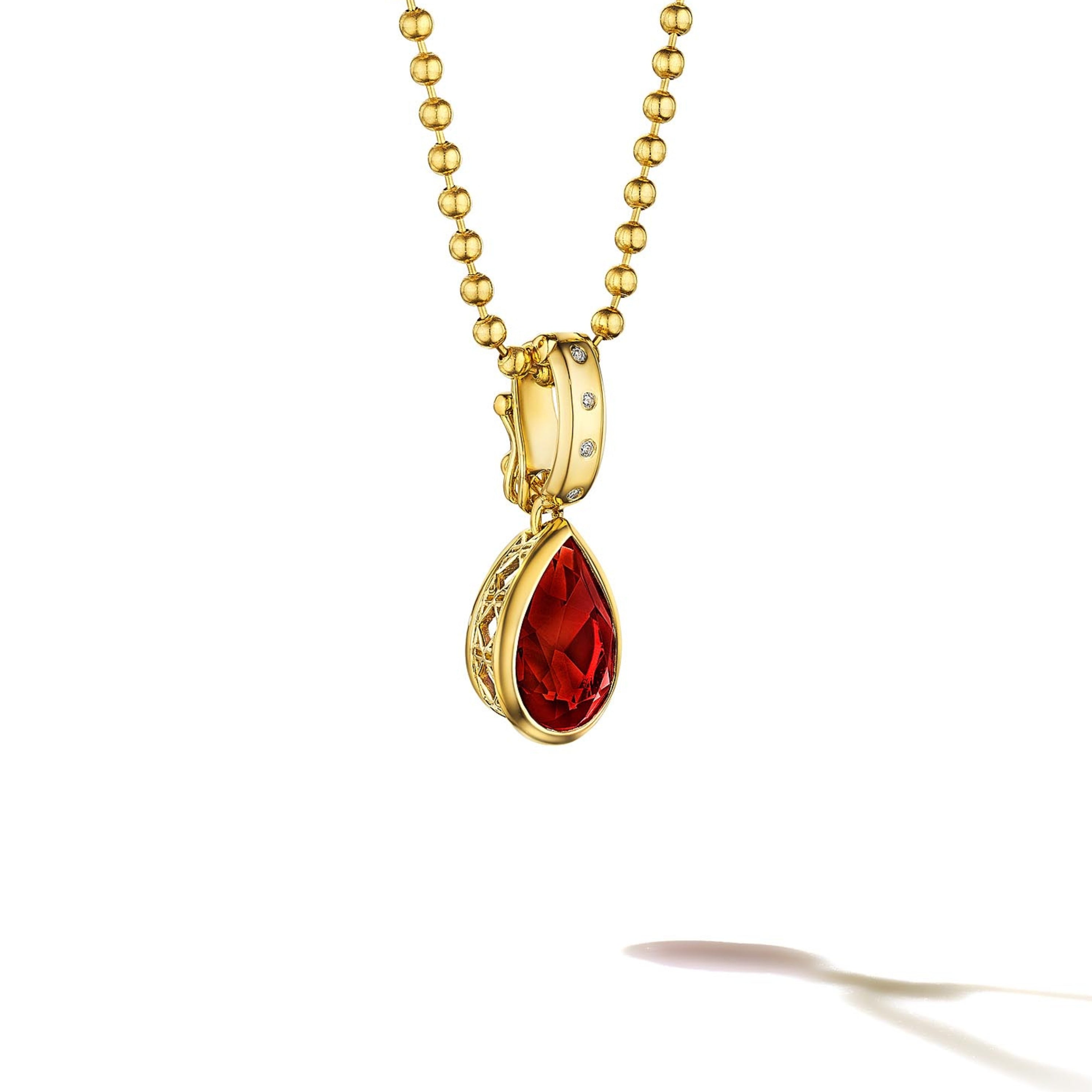 MoAnA LUU Dlo pear-shaped ruby pendant in 18K yellow gold with diamonds, featuring a cane-woven frame inspired by traditional Caribbean fish traps, reflecting the house’s vision of Creole-inspired fine jewelry crafted in New York.
