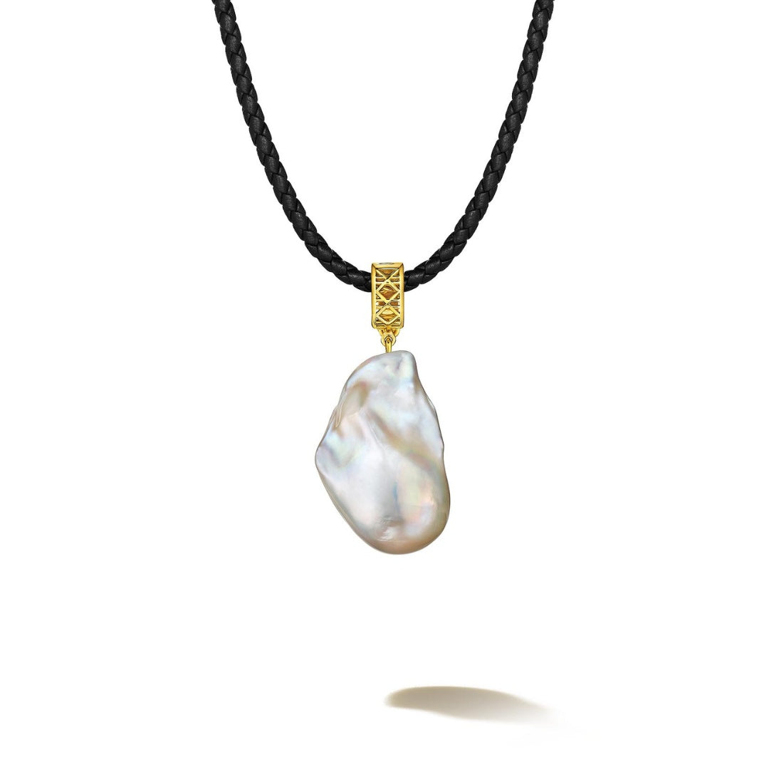 MoAnA LUU Abyss baroque pearl pendant on black leather cord with 18K yellow  gold cane woven bail, inspired by Caribbean fish traps.