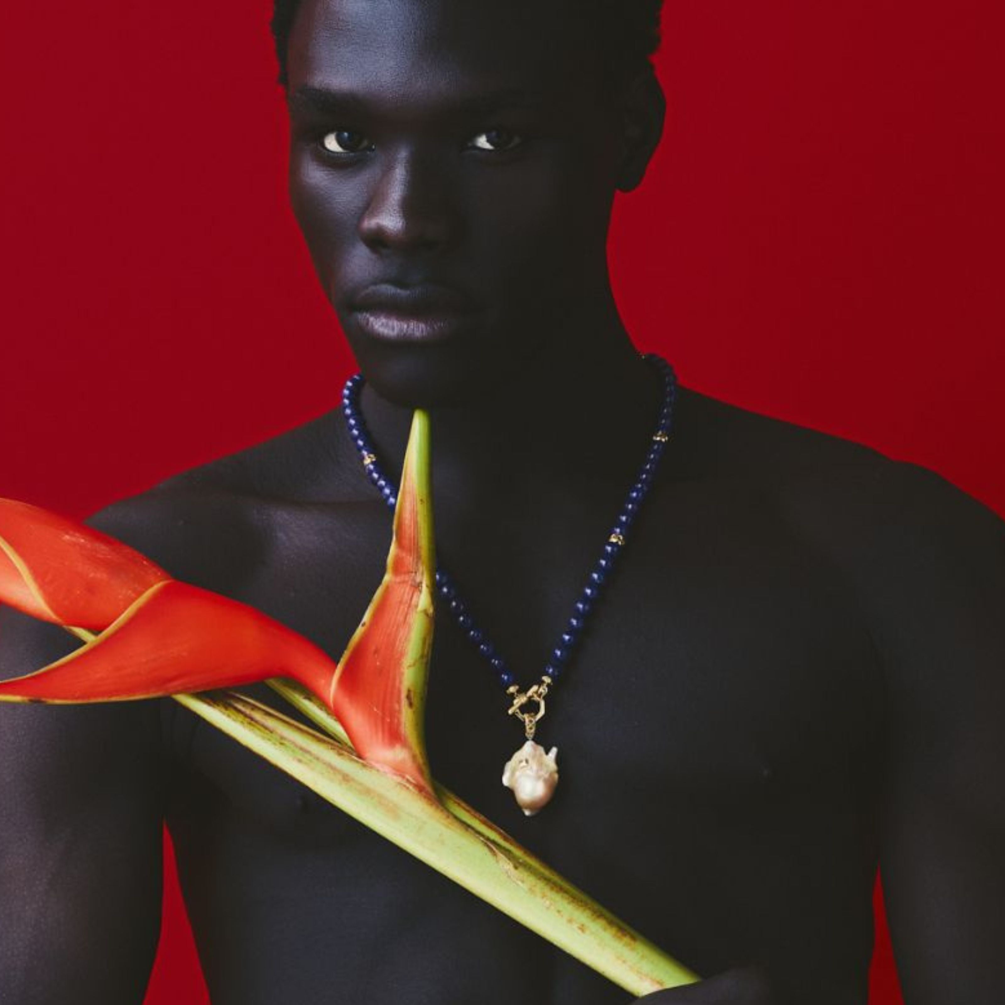 MoAnA LUU Yva beads in lapis lazuli and  18K yellow gold with Abyss South Sea baroque pearl amulet worn by male model. 