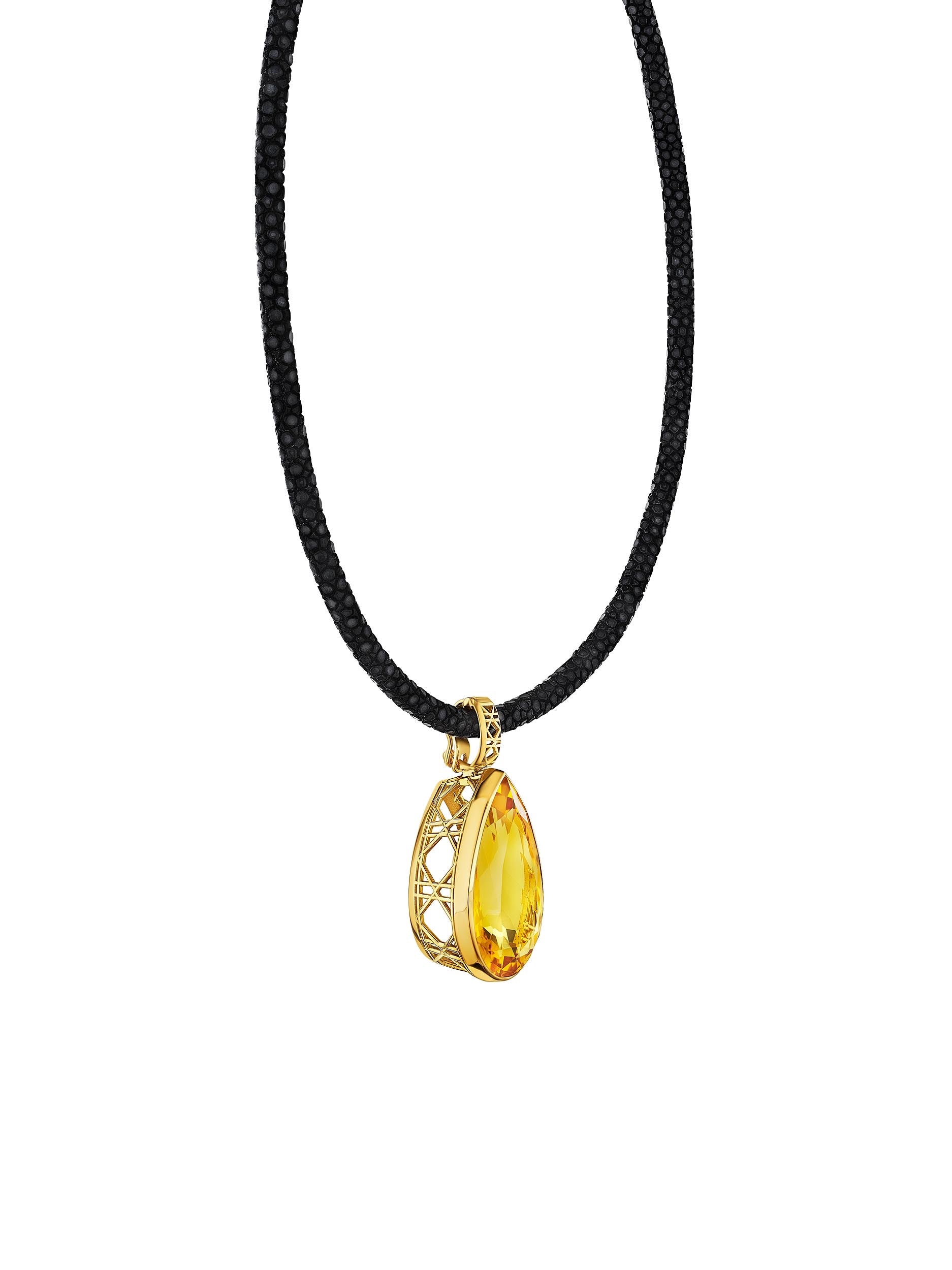 MoAnA LUU Maxi Dlo pear-shaped citrine pendant in 18K yellow gold on a black stingray leather necklace, featuring a sculptural cane-woven bail and openwork basket inspired by Caribbean fish traps.