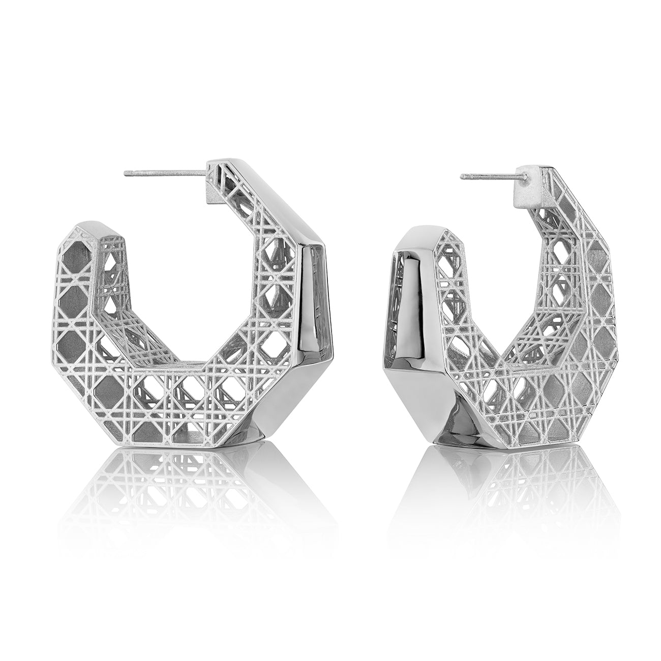 MoAnA LUU Doudou hoop earrings in silver, featuring a cane-woven work inspired by traditional Caribbean fish traps, reflecting the house’s vision of Creole-inspired  jewelry crafted in New York.