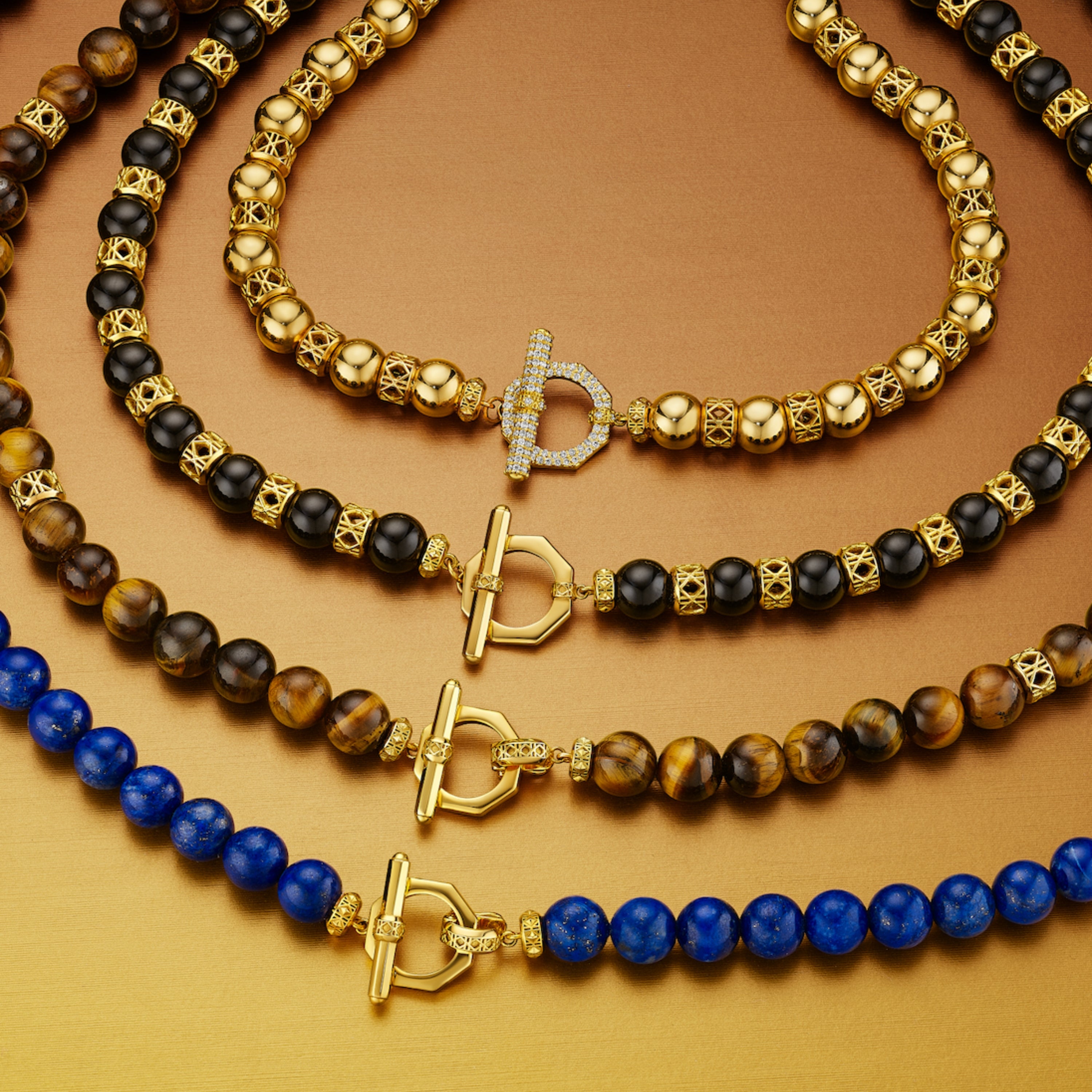 MoAnA LUU Yva bead necklaces in 18K yellow gold with onyx, tiger’s eye, and lapis lazuli beads, featuring signature octagonal toggle clasps and woven accents inspired by Creole craftsmanship.