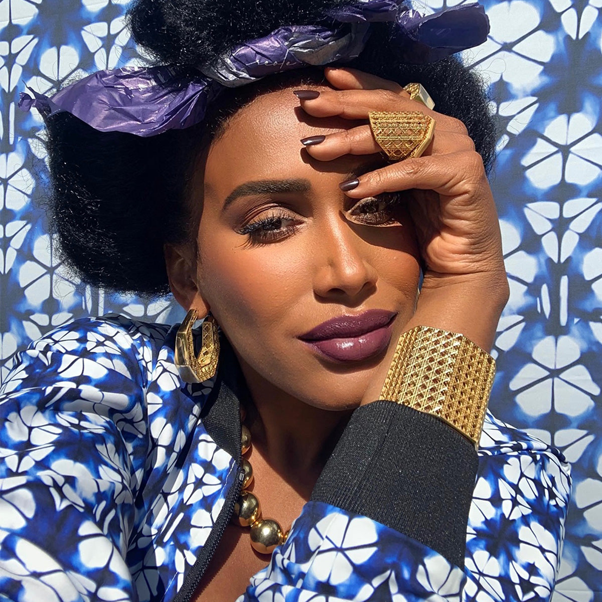 MoAnA LUU wearing MoAnA LUU Doudou Maxi ring, earrings and cuff bracelet 18K yellow gold, featuring a cane-woven work inspired by traditional Caribbean fish traps, reflecting the house’s vision of Creole-inspired fine jewelry crafted in New York.